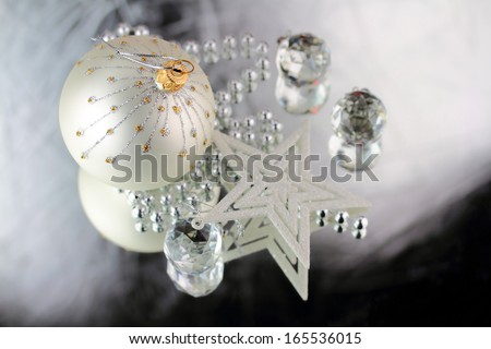 Christmas baubles, Cristal sphere and star on silver background with reflections
