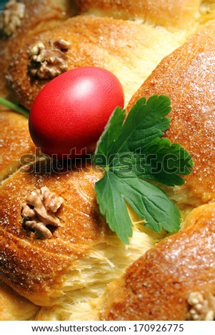 Sweet bread with red Easter egg and Geranium leaf on it