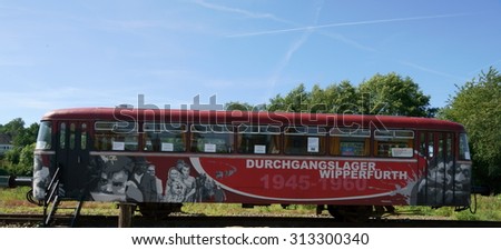Wipperfuerth (Wipperfuerth), Germany - 08/29/2015: painting on a red rail wagon as a memorial to a transit camp from 1945 to 1960 in Wipperfuerth.