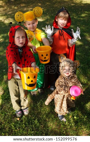 Four boys in halloween costumes trick or treating