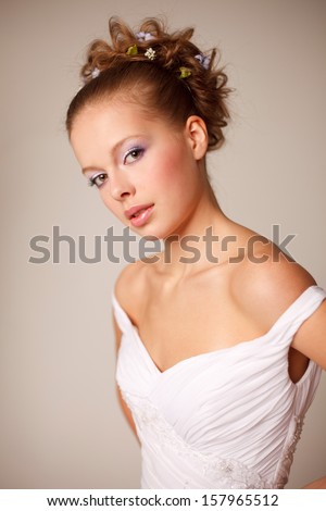 Young classical bride with professional hair style and make-up in pastel colors