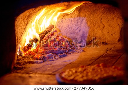 Fireplace burning. Warm burning and glowing fire in traditional brick oven for baked pizza