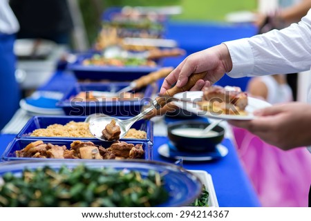 business people group in the line catering buffet food indoor in luxury restaurant with meat colorful rice and vegetables