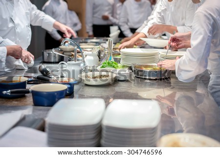 Team of restaurant chef helping each other to finish the good food for customer in five star hotel