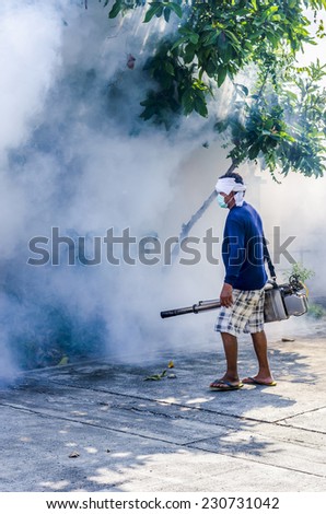 PATHUMTHANI PROVINCE, THAILAND - NOVEMBER 16 2014 : Unidentified man spraying mosquito repellent in village called \