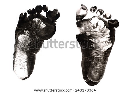 Imprint of children\'s feet on white paper (isolated)