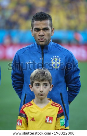 SAO PAULO, BRAZIL - June 12, 2014: Dani Alves during Brazil\'s National Anthem at the FIFA 2014 World Cup opening game. Brazil is facing Croatia in the Group A at Corinthians Arena. No Use in Brazil.