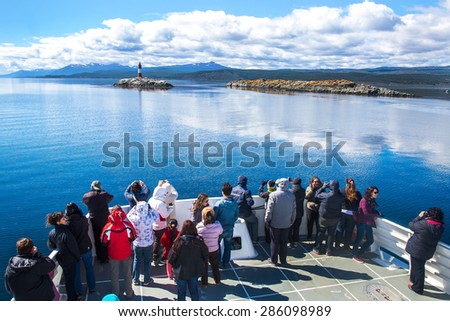 USHUAIA, ARGENTINA - December 28,2014: Tourists visiting a site overlooking the Les Eclaireurs Lighthouse also known as the End of the World Lighthouse located on the Beagle Channel.
