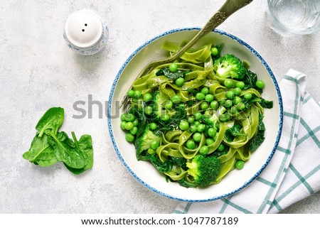 Similar – Image, Stock Photo Green tagliatelle pasta with ham, parmesan cheese, arugula and tomatoes on black plate