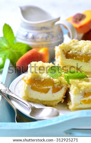 Pieces of peach pie with curd on a light background.