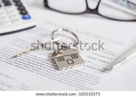 Mortgage loan agreement application with house shaped keyring