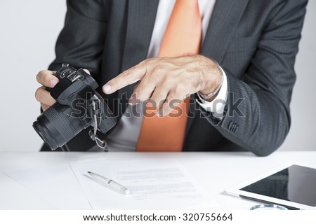 private investigator showing proof on a camera display