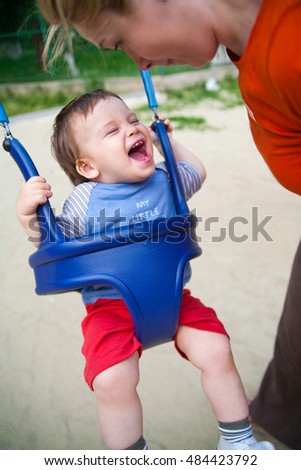 Laughing baby swinging