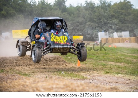 West Sussex, UK - June 29, 2014: Rally buggy jumps over hay bails