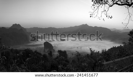 Misty morning light on the top of the mountain hills. Phu Lanka black and white tones.