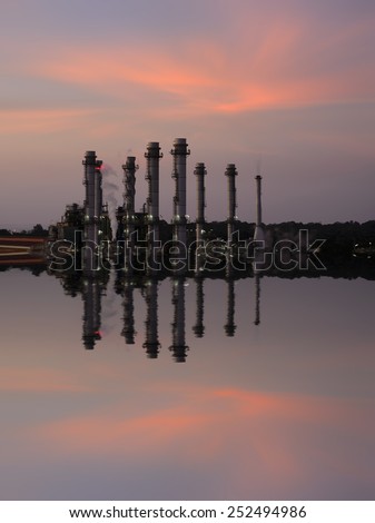 Oil Refinery reflected light water sunset industry in thailand .