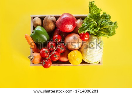 Fresh produce donation box on yellow background Foto stock © 