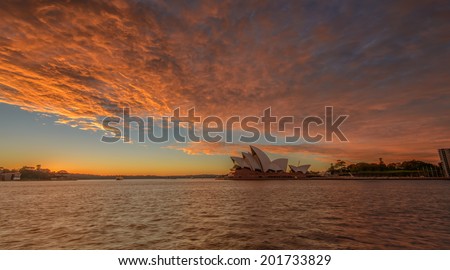 SYDNEY - june 28 : The Sydney Opera House with burning sky, viewed from Circular Quay in Sydney, Australia on June28, 2014 It was designed by Danish architect Jorn Utzon.