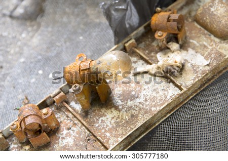 close up of rusty light bulb socket and old rusty light bulb