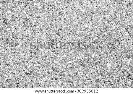 Abstract background of exposed aggregate concrete texture black and white color