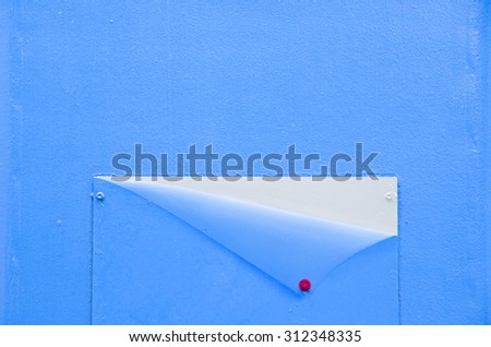 background of Blue wall with metal plate. Concept open sheet with red pin  empty space and border for text