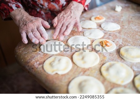 Image, Stock Photo Filling and sealing puff pastry dumplings in a kitchen