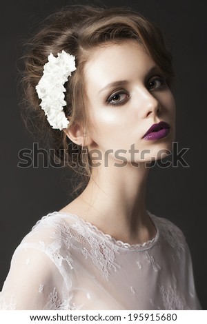 portrait of a beautiful girl with beautiful hair and makeup. purple lips. unusual image of the bride.