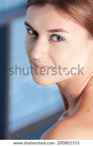 Beautiful face of young adult woman with clean fresh skin and natural make-up