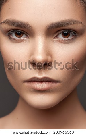 Beautiful face of young adult caucasian woman with clean fresh skin and natural make-up
