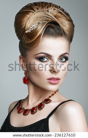 Beautiful young woman with evening make-up and salon hairdo . Smoky eyes. Complicated hairstyle for party