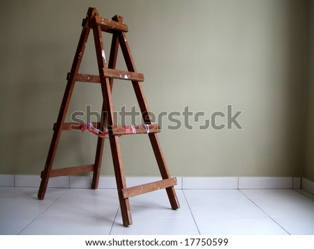 Wooden step ladder alone in a room