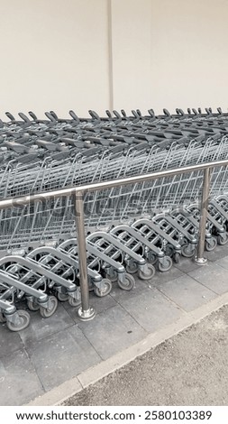 Similar – Image, Stock Photo Shopping carts arranged in the parking and entrance area of a giant warehouse supermarket, on the outskirts of Zaragoza city, Spain.