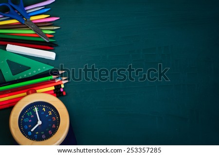 Back to School Background with School Supplies and Alarm Clock