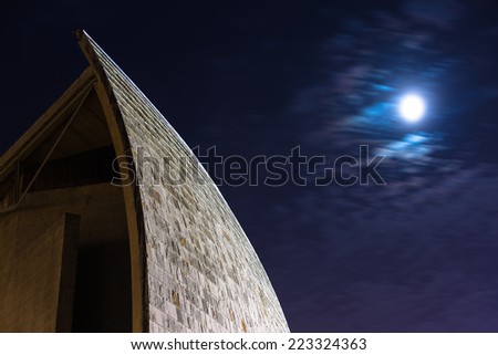 Coruna, Spain - September 2, 2014: Facade of the Humans\' museum, made from granite tiles, lit by moonlight.