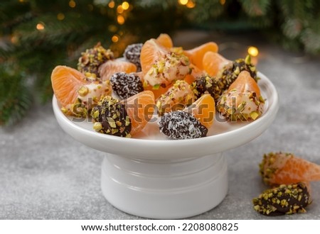 Similar – Foto Bild Orangefarbene Mandarinen in Keramik-Ornamentschale auf Holztisch