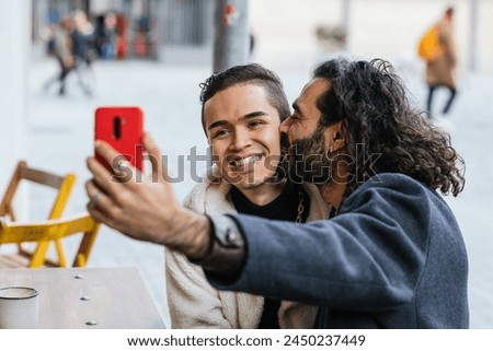 Similar – Image, Stock Photo Cheerful gay couple taking selfie on smartphone