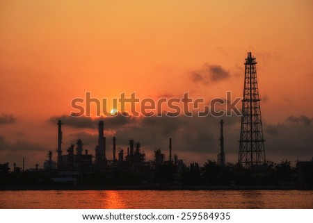 Oil and gas industry - refinery at sunrise - factory - petrochemical plantwith reflection over the river