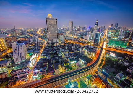 Birds eye view of Bangkok city night with a modern building at . Traffic in the business district