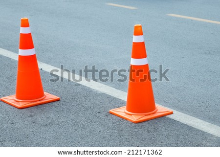 orange traffic cone placed in city street
