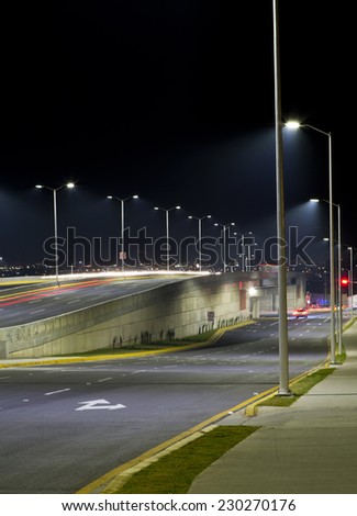 Empty bridge, towers and street lights at night in Guadalajara, Mexico, freeway.