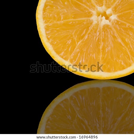Juice half orange in a black back