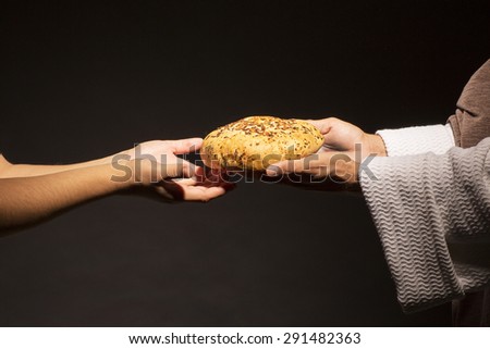 Jesus Christ sharing your bread with the hungry in the dark black night
