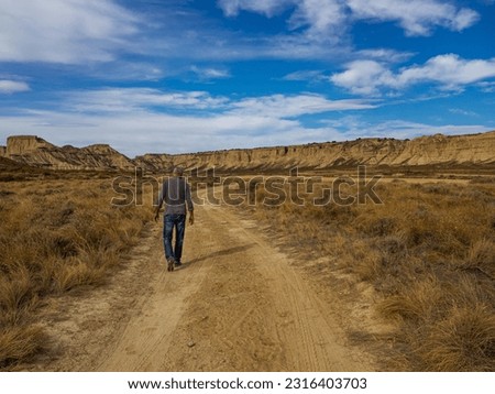 Similar – Image, Stock Photo Male traveler in Bardenas Reales in summer