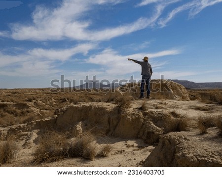 Similar – Image, Stock Photo Male traveler in Bardenas Reales in summer