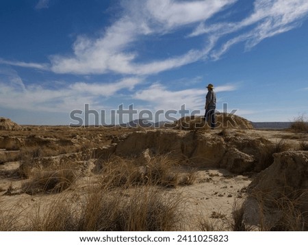 Similar – Image, Stock Photo Male traveler in Bardenas Reales in summer