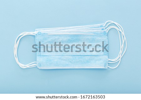 Prevent coronavirus. Medical mask, Medical protective mask isolated on blue background. Disposable surgical face mask cover mouth and nose. Healthcare medical Coronavirus quarantine, hygiene concept