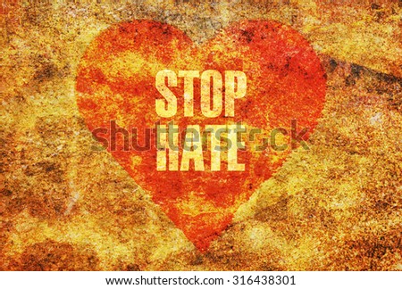 Text Stop Hate written with golden letters on a red heart