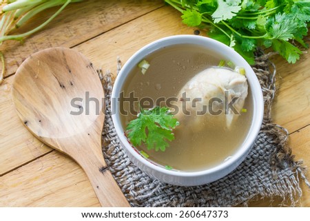 Chicken soup, chicken soup in a cup with a sack on the table.