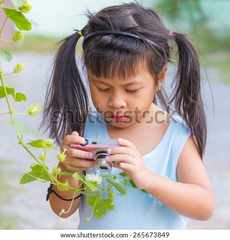 little asia girl taking photo