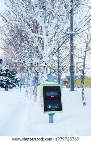 Green anti-slip sandbag box beside the sidewalk in snowy areas in Japan 商業照片 © 